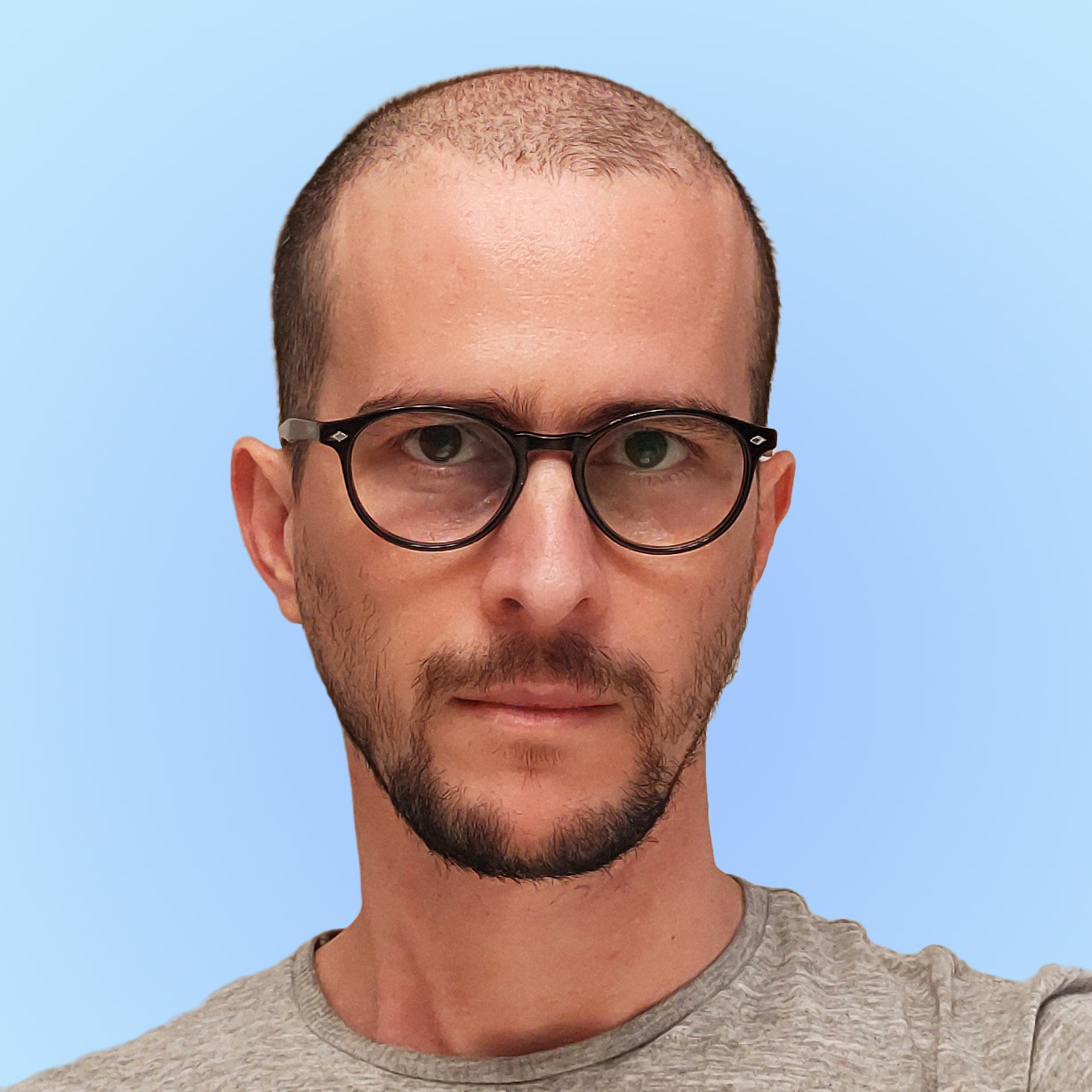 Picture of myself. I am a white male with a shaved head, dark-rimmed black glasses, and a short beard.